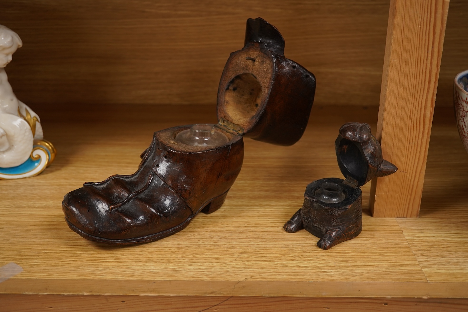 A Black Forest carving of a kitten in a boot inkwell and another car inkwell, tallest 15cm